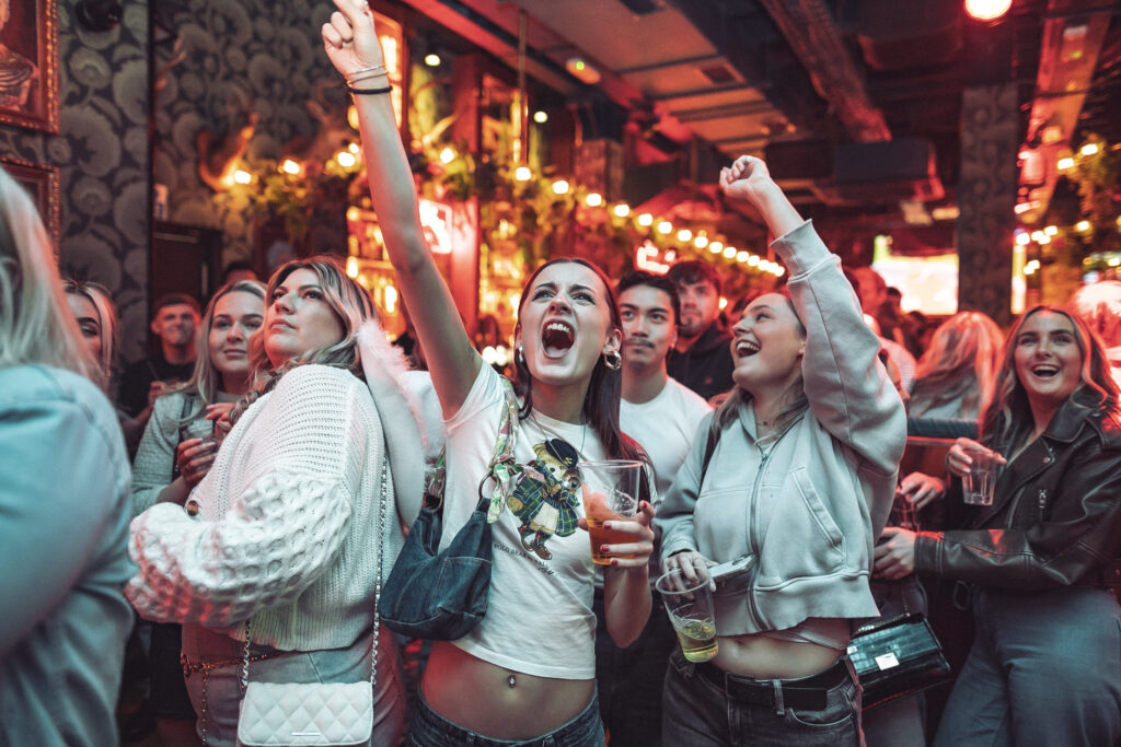Fans cheering at the TV