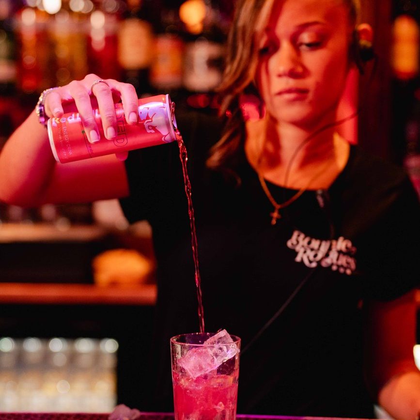 Bartender pouring specialty cocktail in Swansea