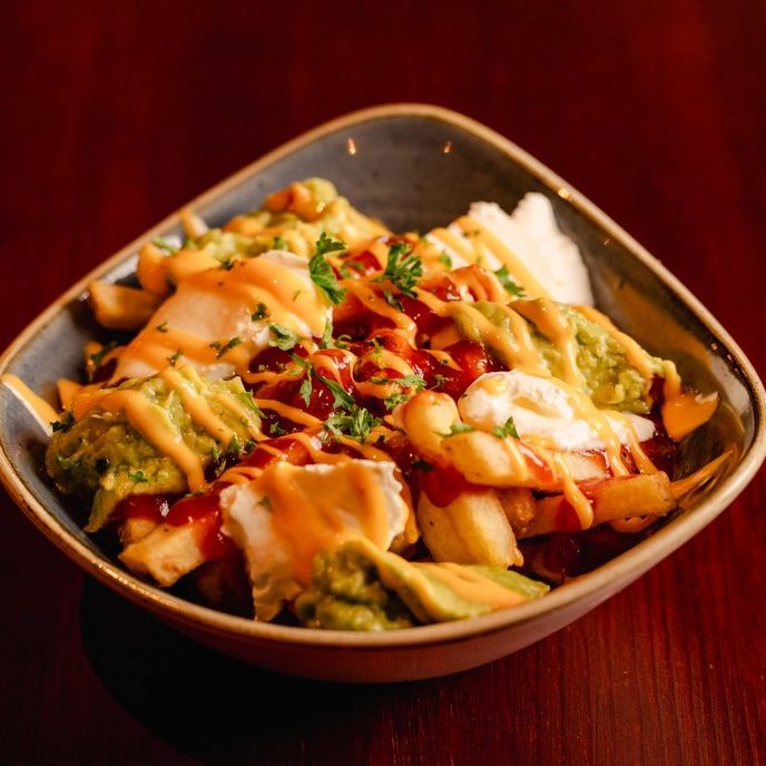 Loaded nachos and small sharing dishes in Swansea